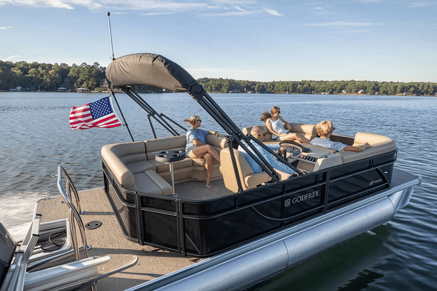 Group enjoying a sunny day on a pontoon boat with an American flag.
